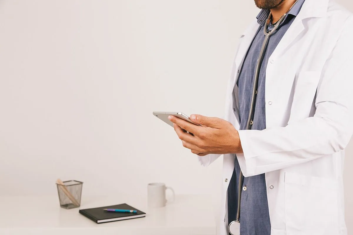 A pharmacist texting on a phone